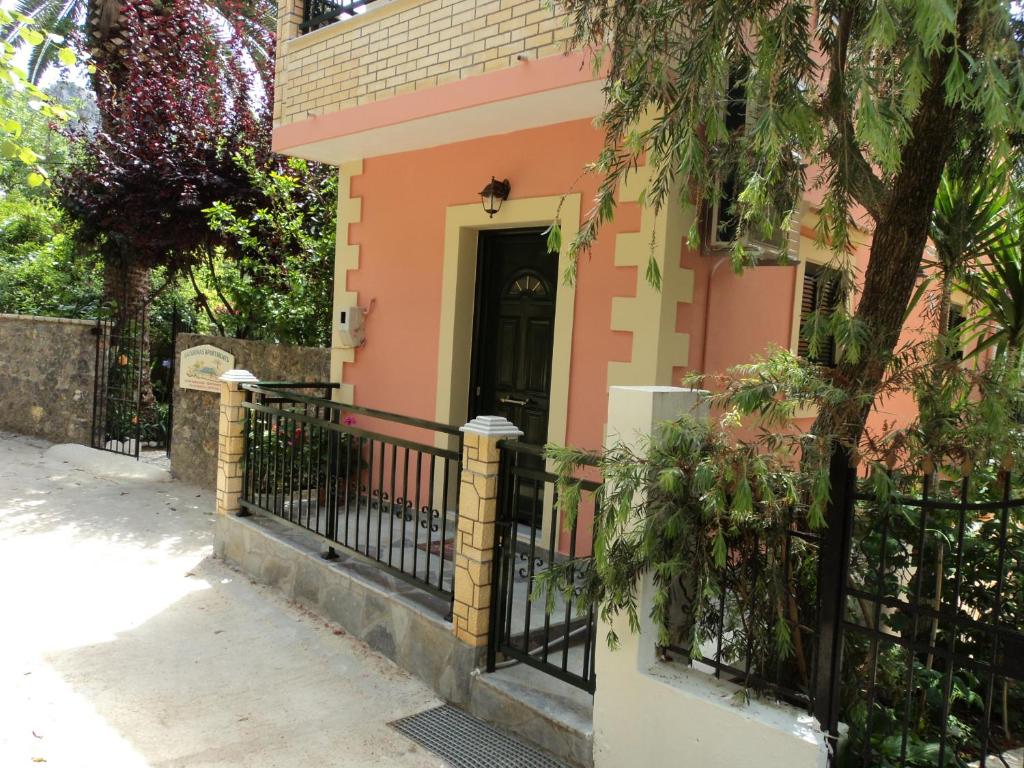 a house with a black door and a fence at Maistralis House in Agios Gordios