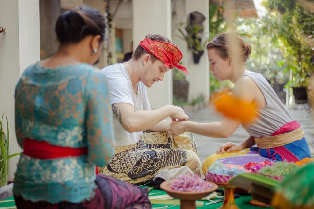 a group of three women looking at something at Grandmas Plus Hotel Seminyak in Seminyak