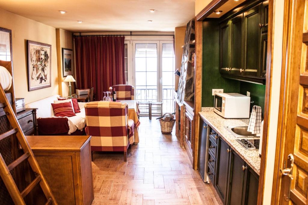 a living room with a kitchen and a living room with a couch at IMEDA apartamento ATLAS Sierra Nevada in Sierra Nevada