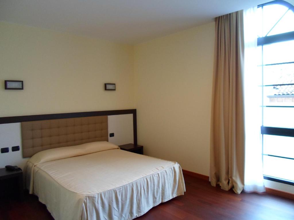 Postel nebo postele na pokoji v ubytování Hotel Le Macine