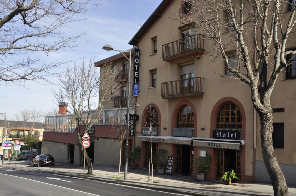 a building on the corner of a street at Hotel Tres Arcos in San Lorenzo de El Escorial