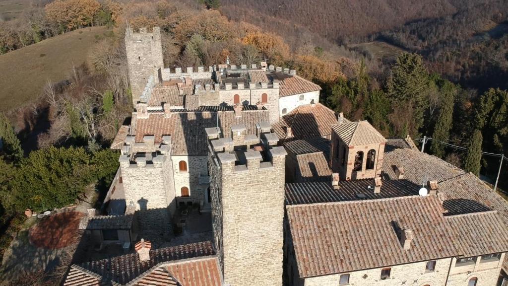 an aerial view of a castle in the mountains at Castello Di Giomici in Valfabbrica
