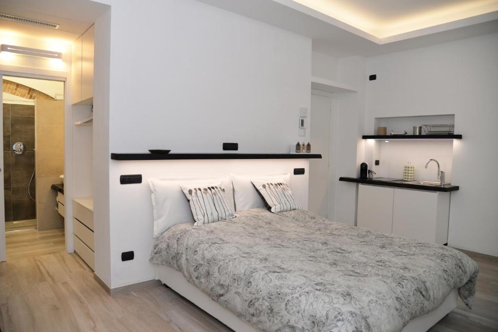 a white bedroom with a large bed with pillows at Civico29 Rooms & Breakfast in Como