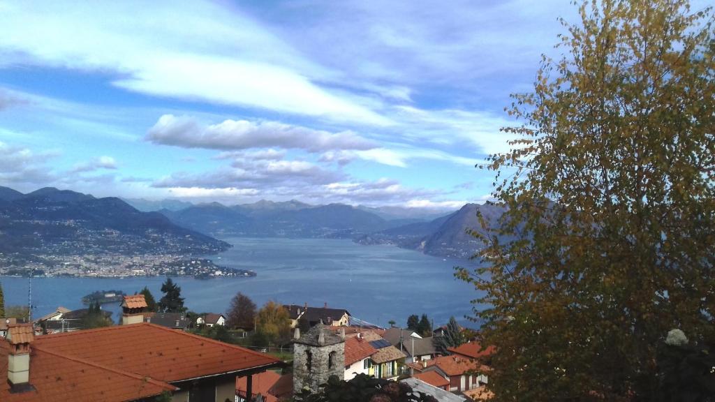 a view of a town and a lake with mountains at Casa Elisa in Stresa