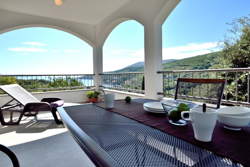 a dining table on a balcony with a view at Apartment Andrea in Sveta Marina