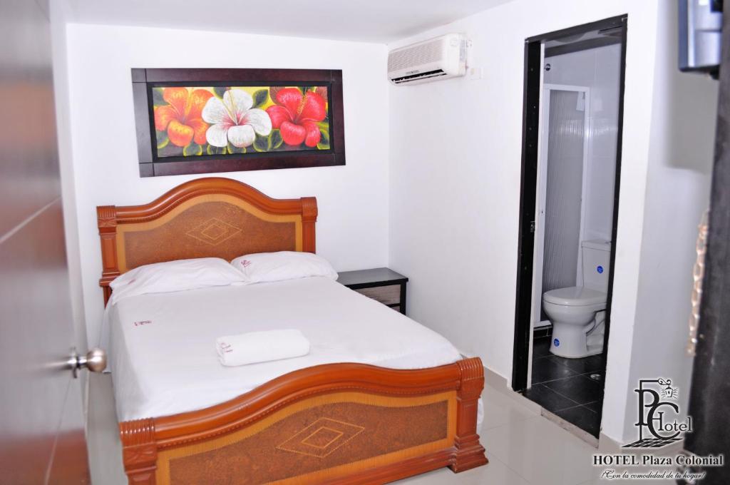 Postel nebo postele na pokoji v ubytování Hotel Plaza Colonial