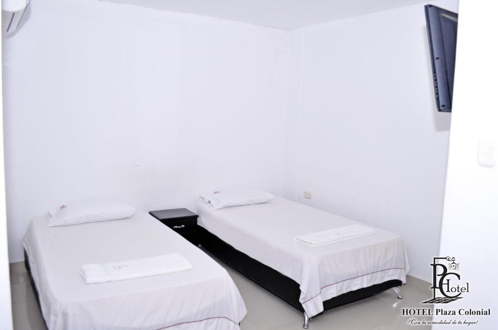 Postel nebo postele na pokoji v ubytování Hotel Plaza Colonial