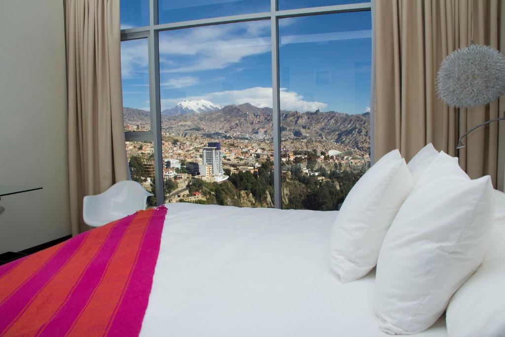 a bedroom with a large bed with a large window at Stannum Boutique Hotel & Spa in La Paz