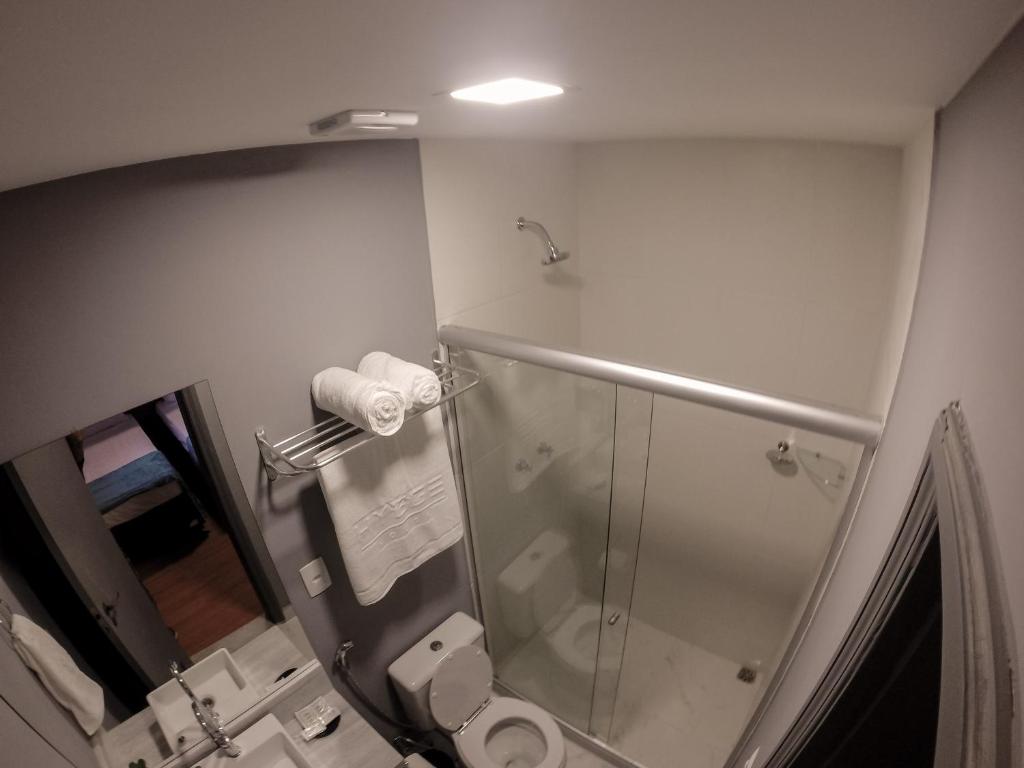 a bathroom with a glass shower and a toilet at REF House Barra Da Tijuca in Rio de Janeiro