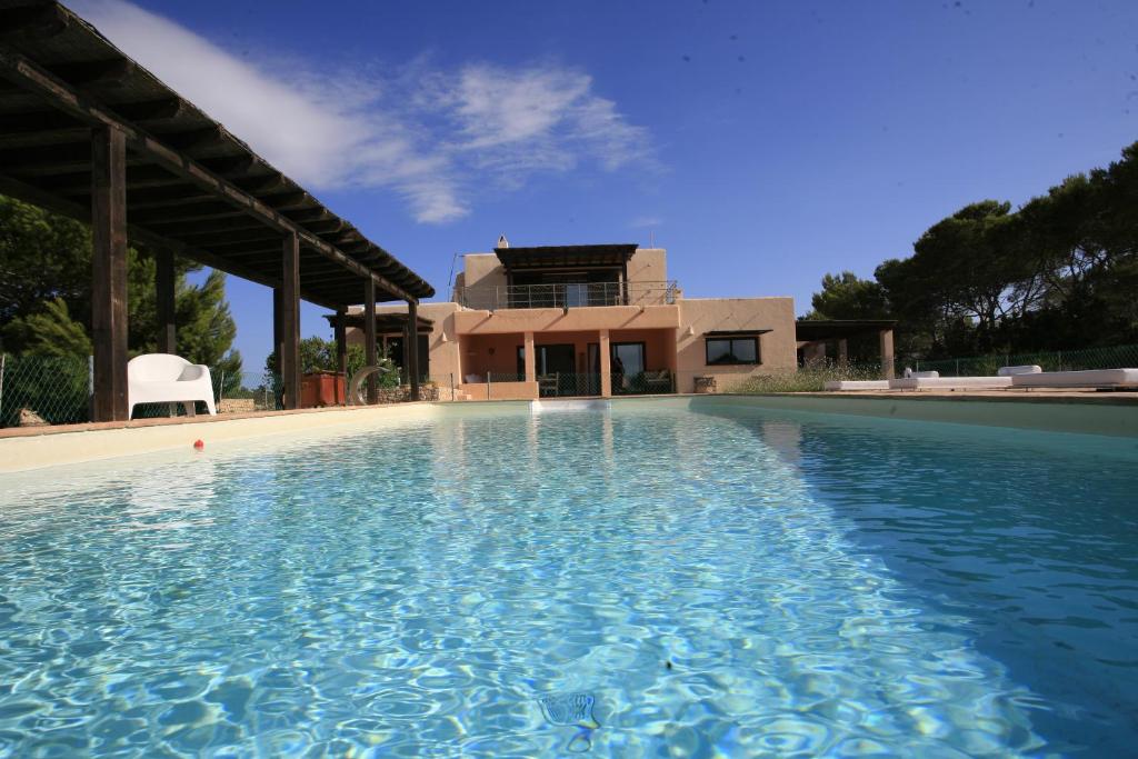 a swimming pool in front of a house at Daniela in Sant Francesc Xavier