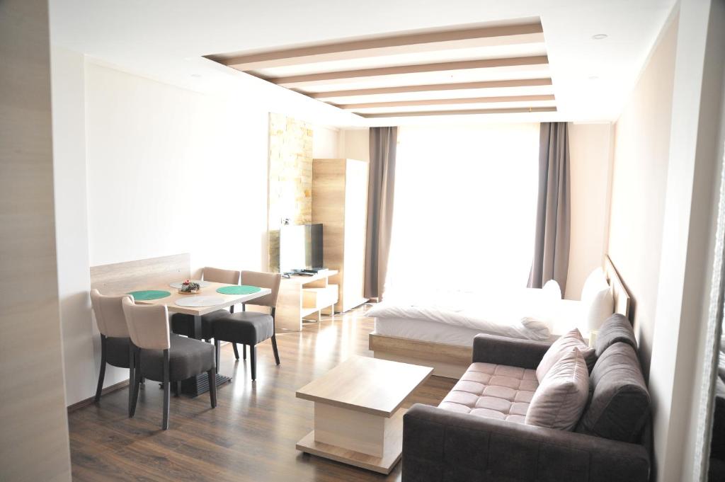 a living room with a couch and a table at Apartments Milmari M 6.7.8 in Kopaonik