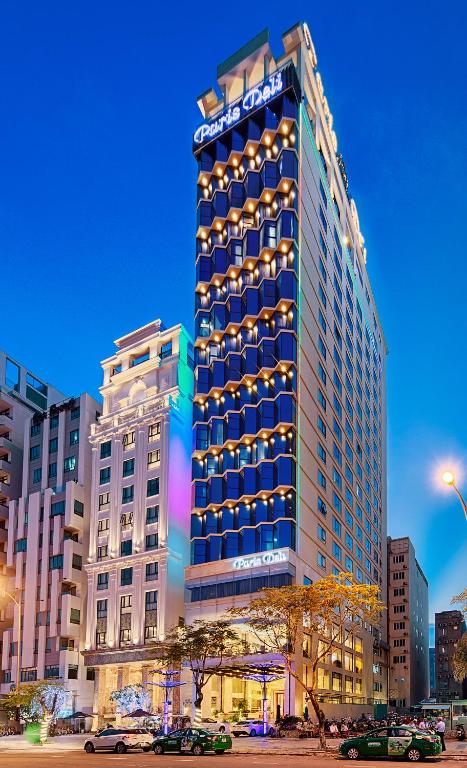 a tall building with lights on the side of it at Paris Deli Danang Beach Hotel in Danang
