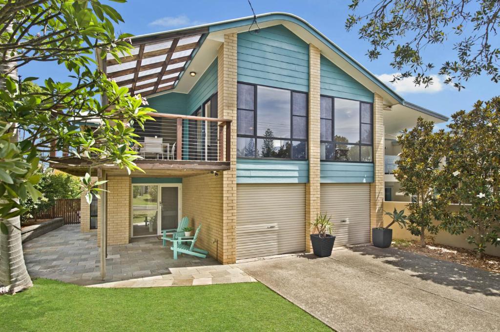 a house with a deck and a balcony at Amara 6 Wesley Avenue in Port Macquarie