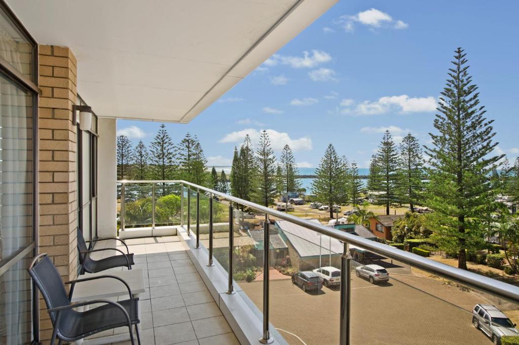 a balcony with chairs and a view of a street at Tasman Towers 12 3 Munster Street in Port Macquarie
