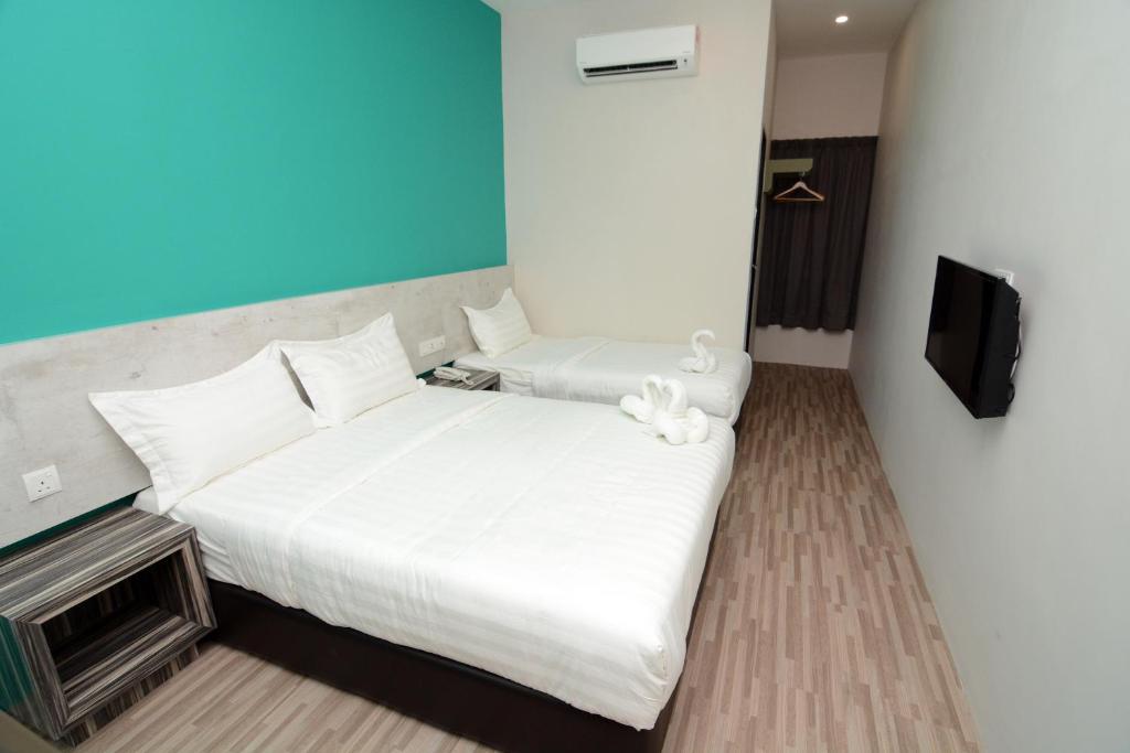 Postel nebo postele na pokoji v ubytování Eco Garden Hotel