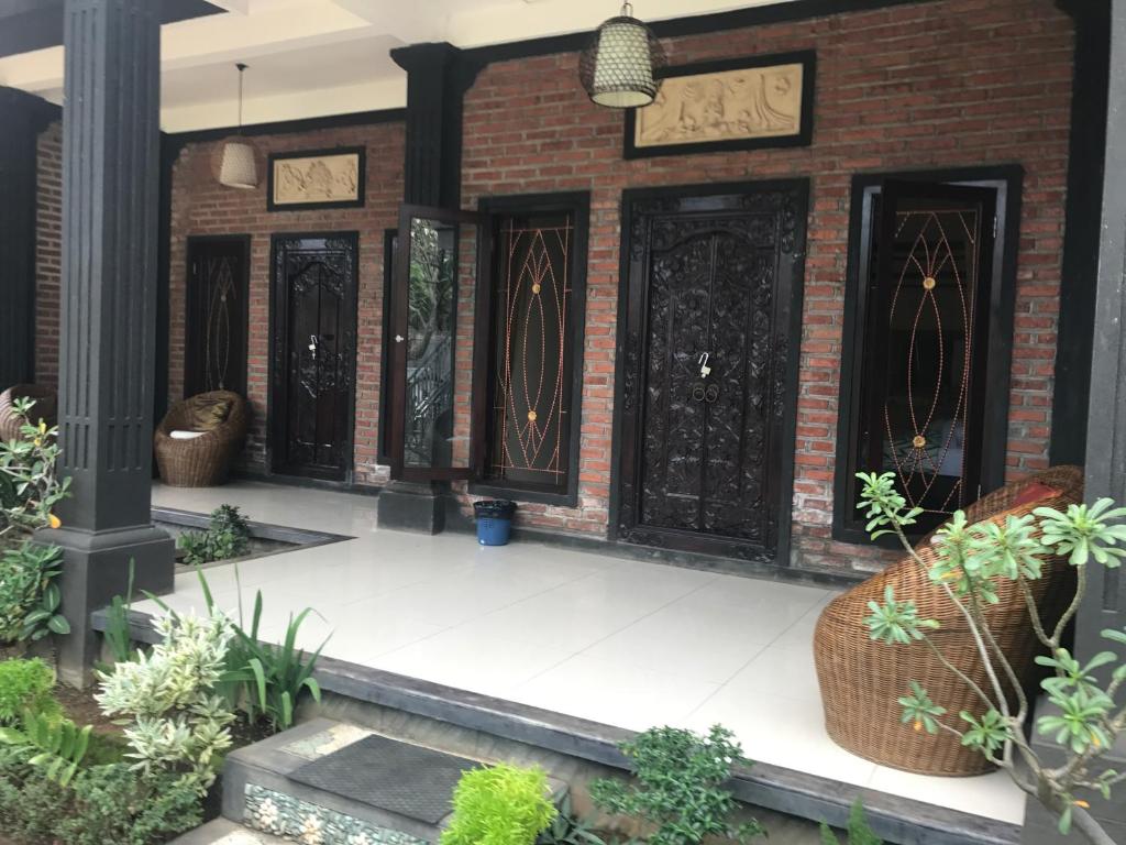 a row of doors on a brick building with plants at Murni’s House in Lovina