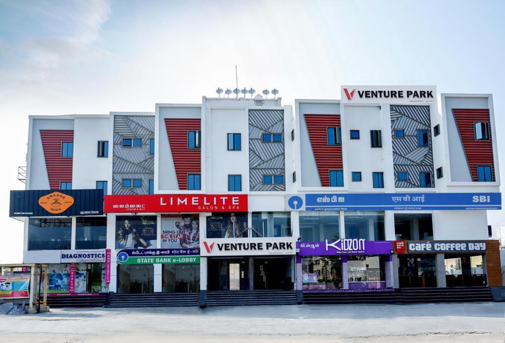 a large white building with shops in front of it at Venture Park, OMR, Thoraipakkam, Chennai in Chennai