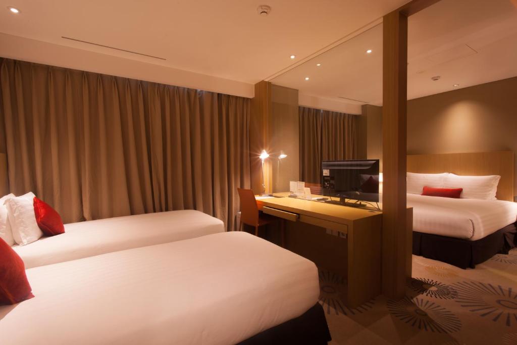 Postel nebo postele na pokoji v ubytování Solaria Nishitetsu Hotel Busan