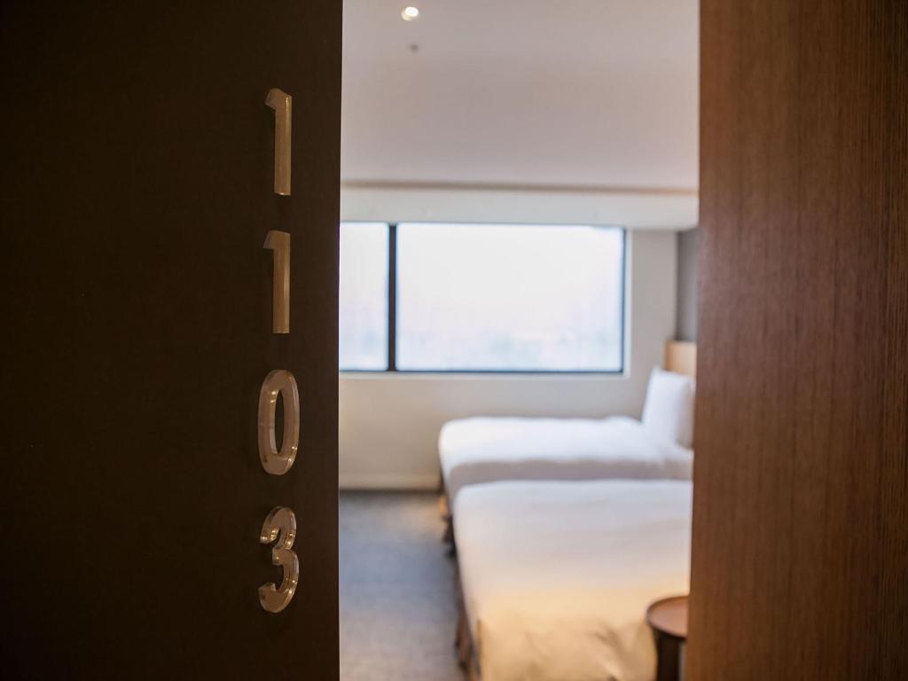Postel nebo postele na pokoji v ubytování Royal Inn Taipei Linsen - Huashan 1914 Creative Park