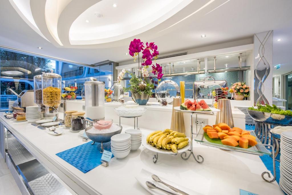 A bright self-service breakfast buffet with fruit, cereal, yogurt and drinks.