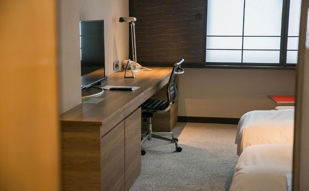 Postel nebo postele na pokoji v ubytování Royal Inn Taipei Nanxi - MRT Zhongshan Station