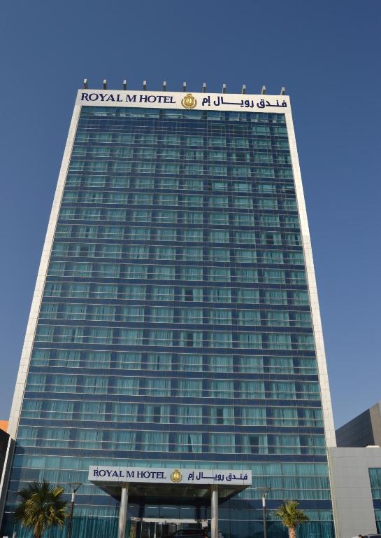 a tall building with a sign on top of it at Royal M Hotel Fujairah by Gewan in Fujairah