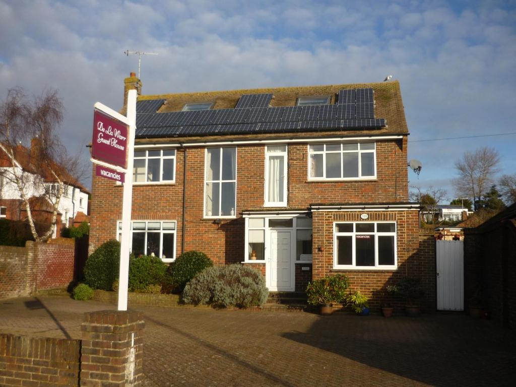 a house with solar panels on the roof at De La Warr Guest House in Bexhill