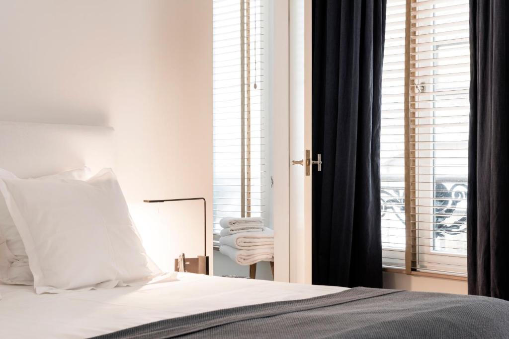 Postel nebo postele na pokoji v ubytování Hotel Julien