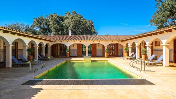 a house with a swimming pool in a courtyard at Sa Legitima in Ciutadella