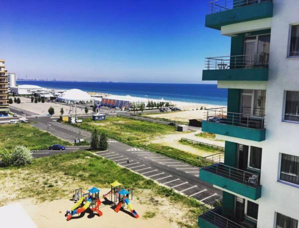 a view of the beach from a balcony of a building at Studio Summerland in Mamaia