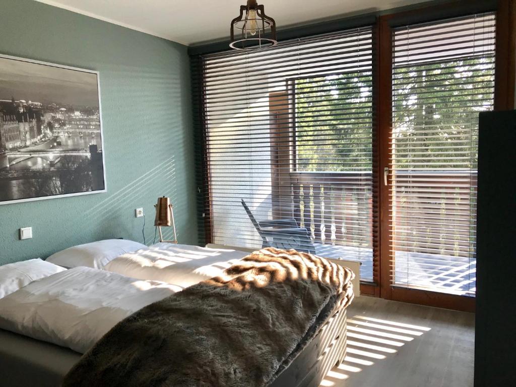 a bedroom with two beds and a large window at Kappeberg Lodge in Winterberg