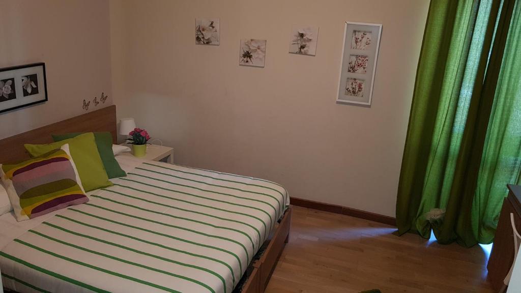 a bedroom with a bed with a green curtain at Antico Casale in Turin