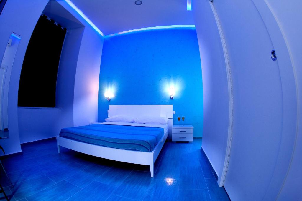 a blue bedroom with a bed in a room at Mergellina Resort in Naples