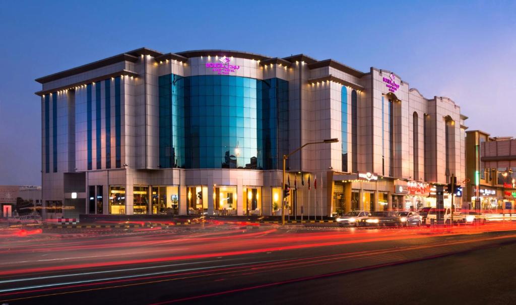 a large building on a city street at night at Boudl Taif in Taif