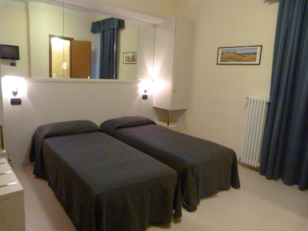 Postel nebo postele na pokoji v ubytování Hotel Aurora