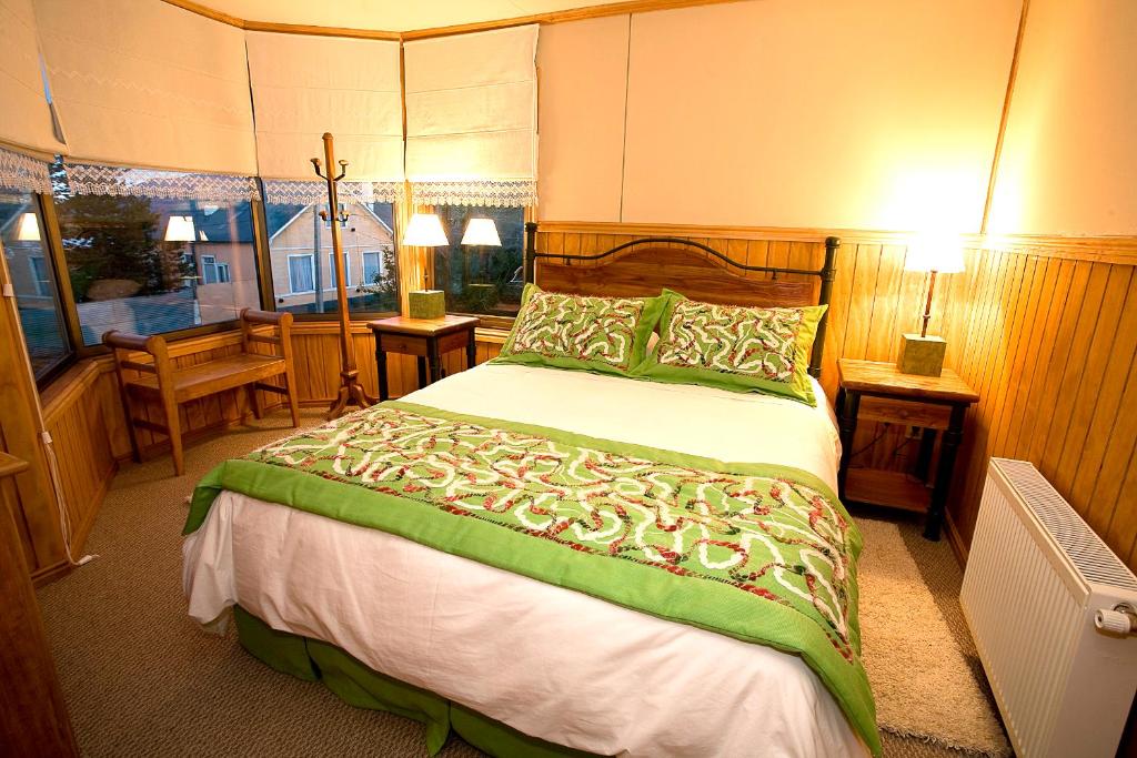 a bedroom with a large bed and a window at Keoken Patagonia in Puerto Natales