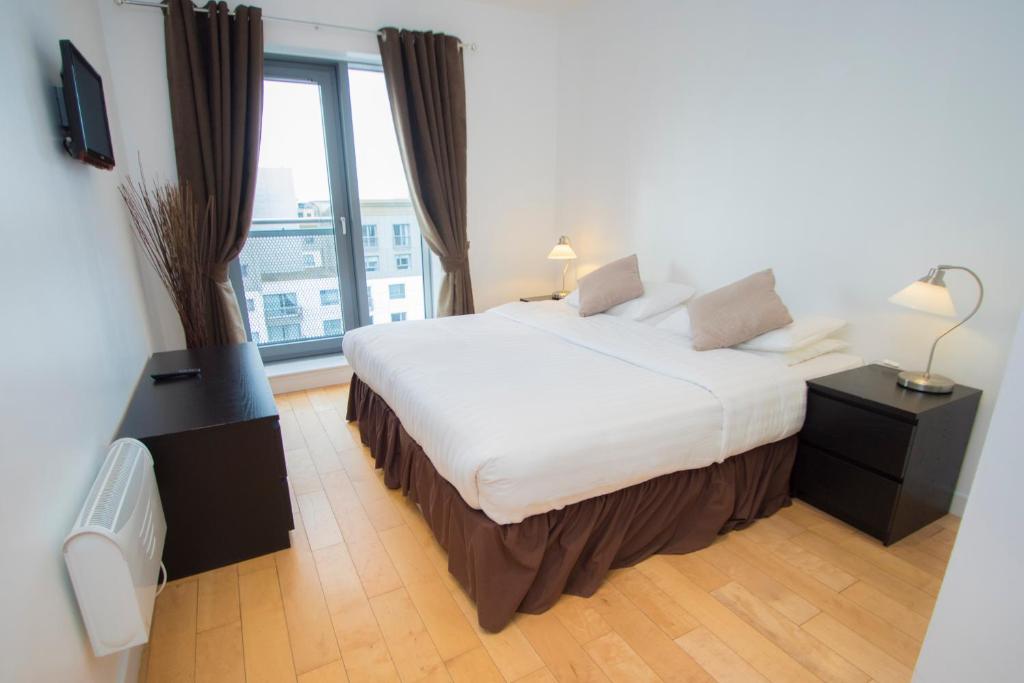 Postel nebo postele na pokoji v ubytování Ocean Serviced Apartments