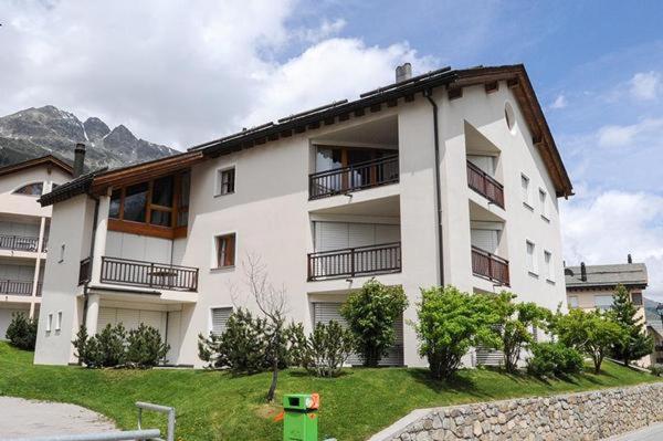 a white building with balconies on the side of it at Palüdetta 8 in Silvaplana