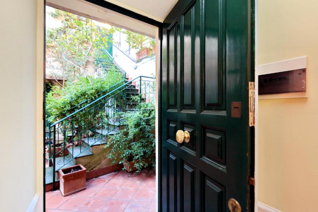 zielone drzwi prowadzące na patio ze schodami w obiekcie Characteristic apartment just beside the Vatican w Rzymie