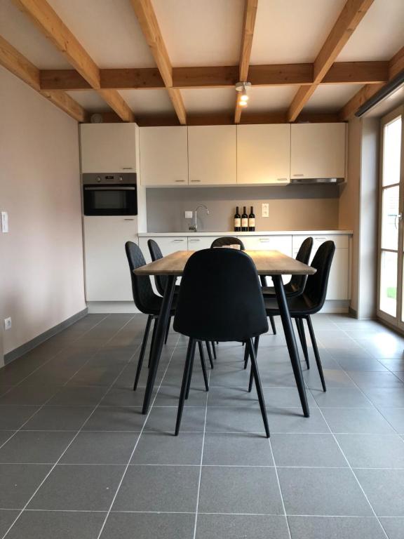 a kitchen and dining room with a table and chairs at Beachhouse Wenduine 25 in Wenduine