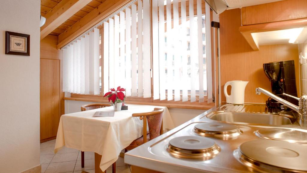 a kitchen with a table and a sink and a window at Alpenblick in Zermatt