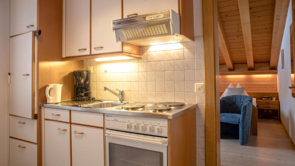 a kitchen with a sink and a stove top oven at Alpenblick in Zermatt