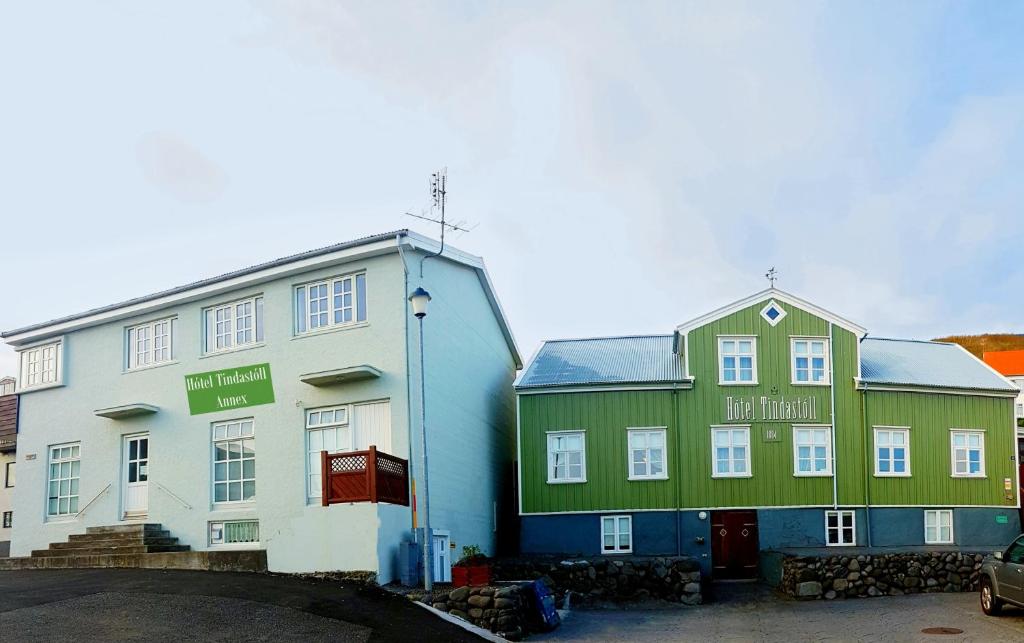 two buildings in a parking lot next to each other at Hótel Tindastóll in Sauðárkrókur