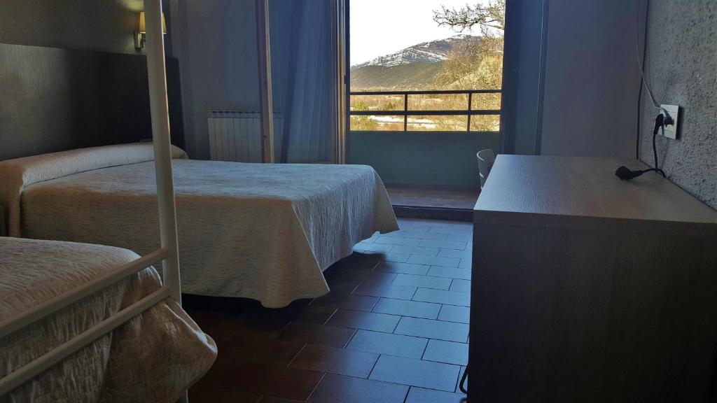 Postel nebo postele na pokoji v ubytování Hotel Meson de L’Ainsa