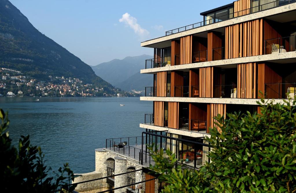 a large building with a balcony overlooking the water at Il Sereno Lago di Como in Torno