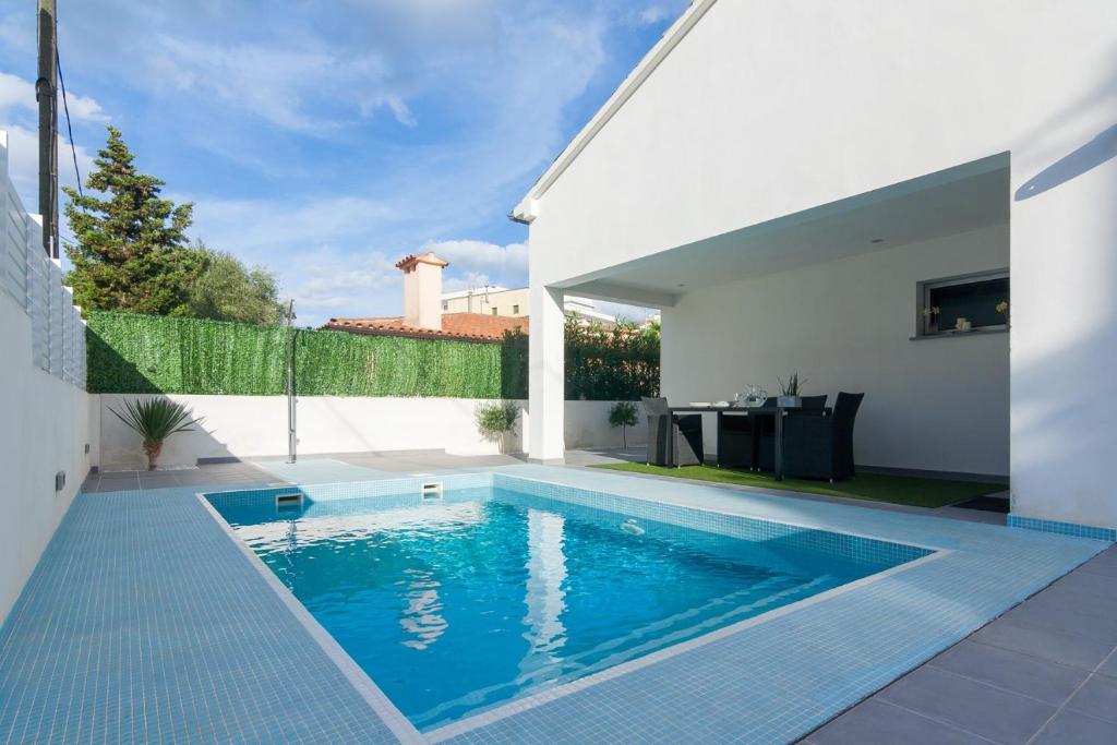 a swimming pool in the backyard of a house at Llevant in Can Picafort