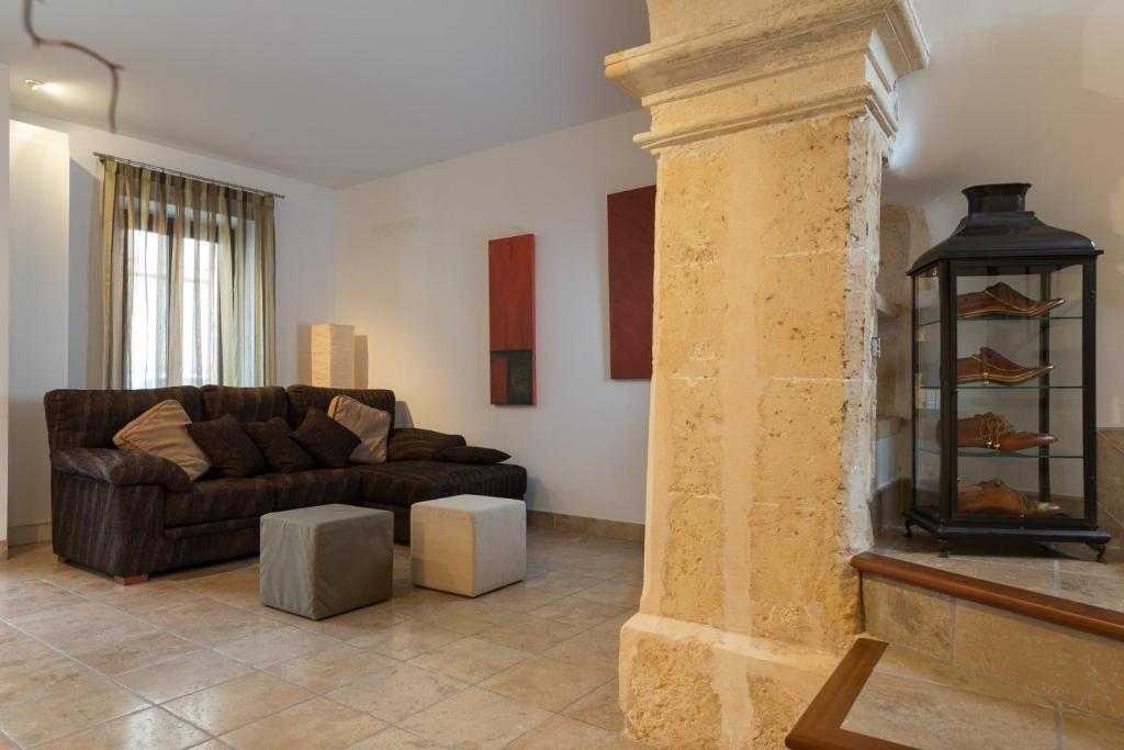 a living room with a couch and a fireplace at Casa Puça in Sa Pobla