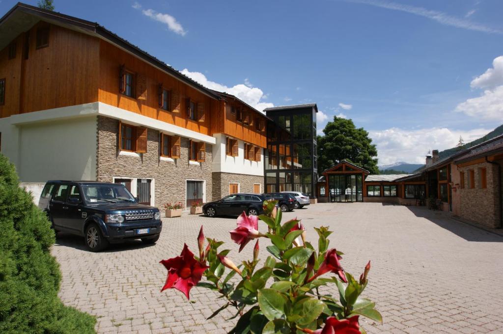 a car parked in a parking lot next to a building at Hotel Europa in Bardonecchia