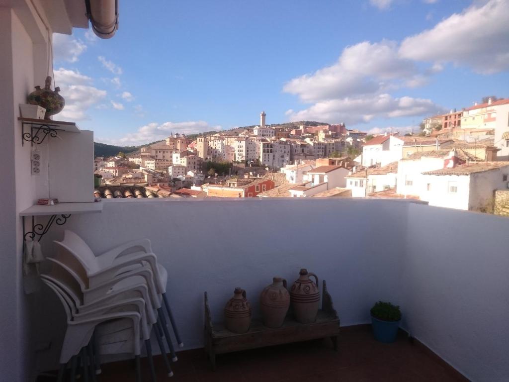 a balcony with chairs and a view of a city at La terraza de Maxi Casa completa in Cuenca