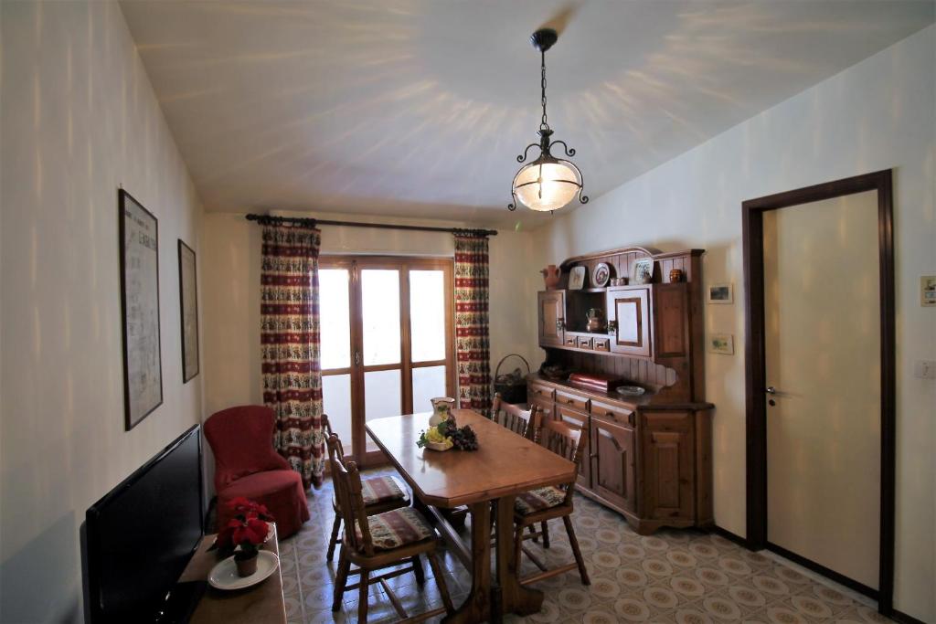 a living room with a table and a dining room at Casa Soleil by Holiday World in Limone Piemonte